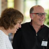 Two guests laugh together in the lobby